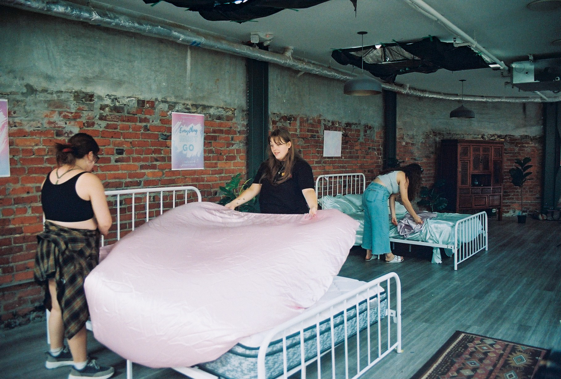 Nothing Mattress set dressing with beds being made in the location